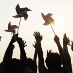 People holding pinwheels